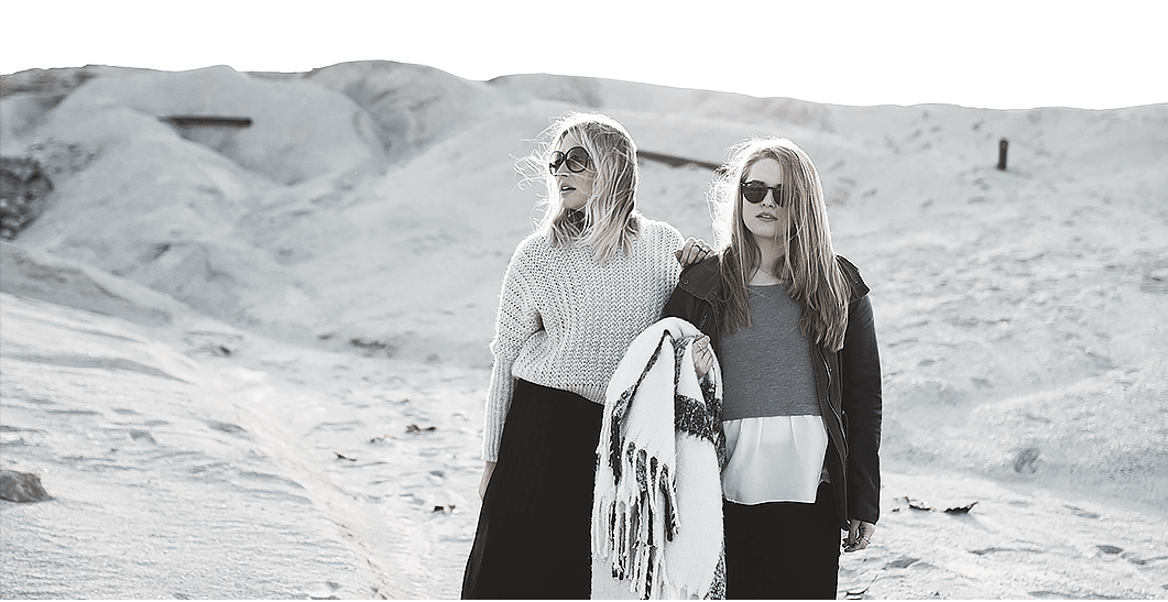Two girls in front of the mountain